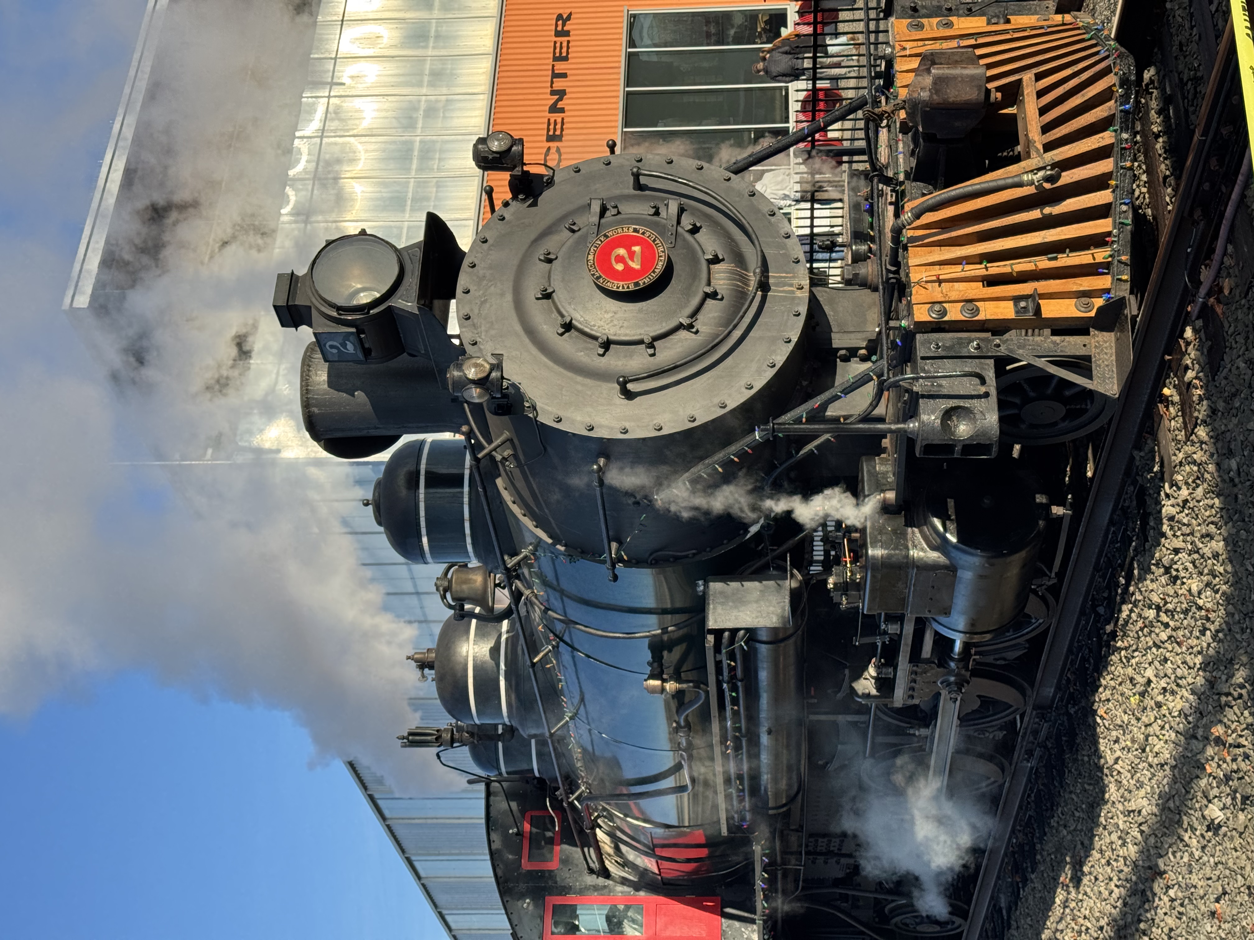 Family aboard the Holiday Express train with twinkling lights