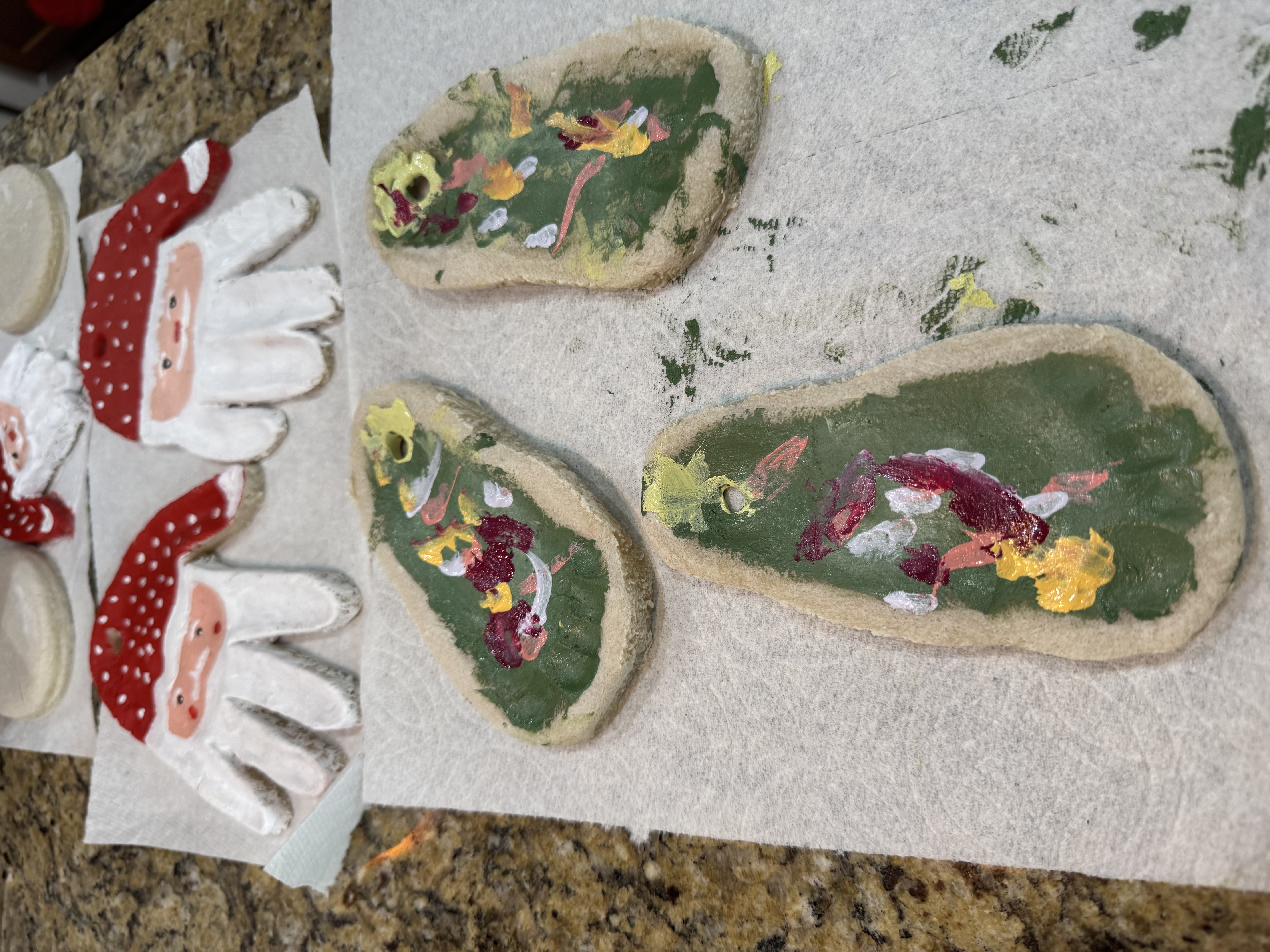 Toddler hands playing with dough on a flour-dusted counter