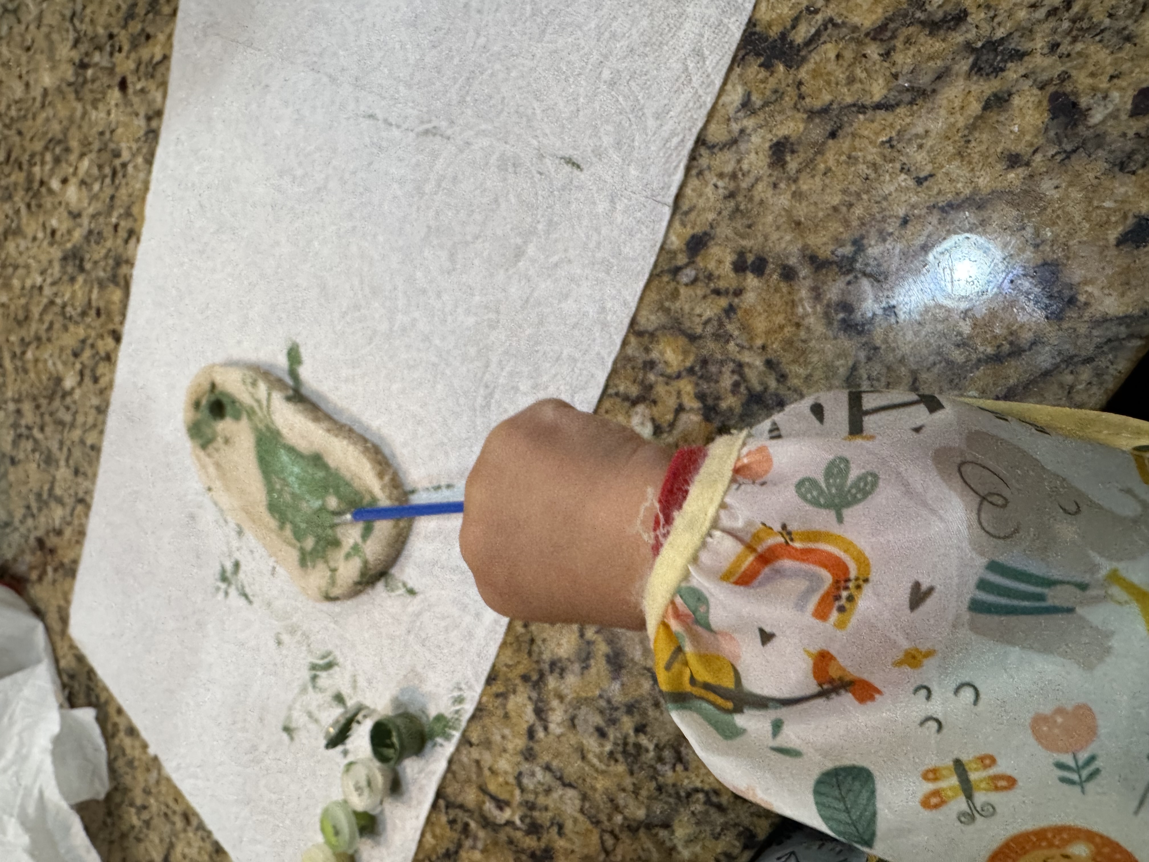 Annabrodea helping her child cut out ornament shapes